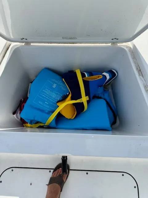Slide: The Image of Open storage compartment with life jackets on a 2016 Sportsman Island Reef 19 Center Console boat. - 21