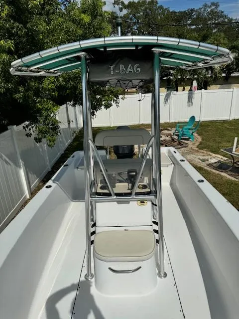 Slide: The Image of 2016 Sportsman Island Reef 19 Center Console boat with T-top in a backyard setting. - 23