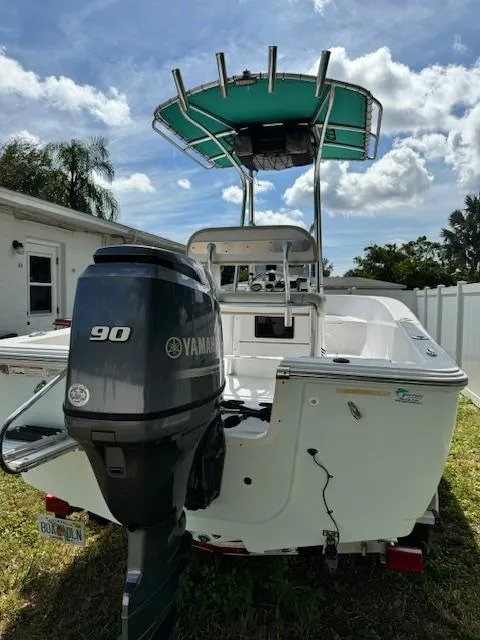 Slide: The Image of 2016 Sportsman Island Reef 19 Center Console boat with Yamaha 90 engine, parked outdoors. - 3