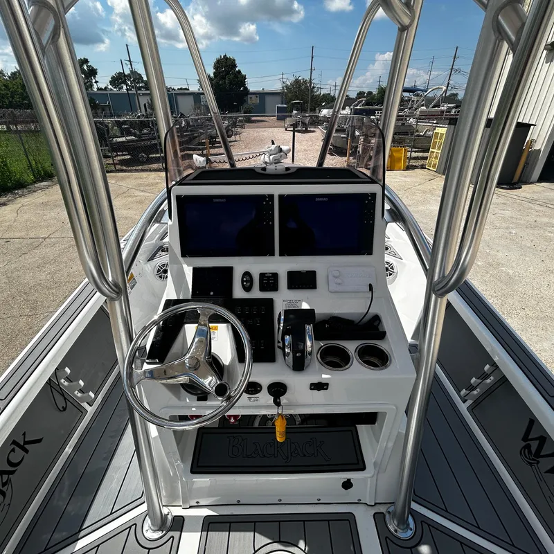 Slide: The Image of 2021 BlackJack 256 Bay boat console with steering wheel and dual screens. - 15