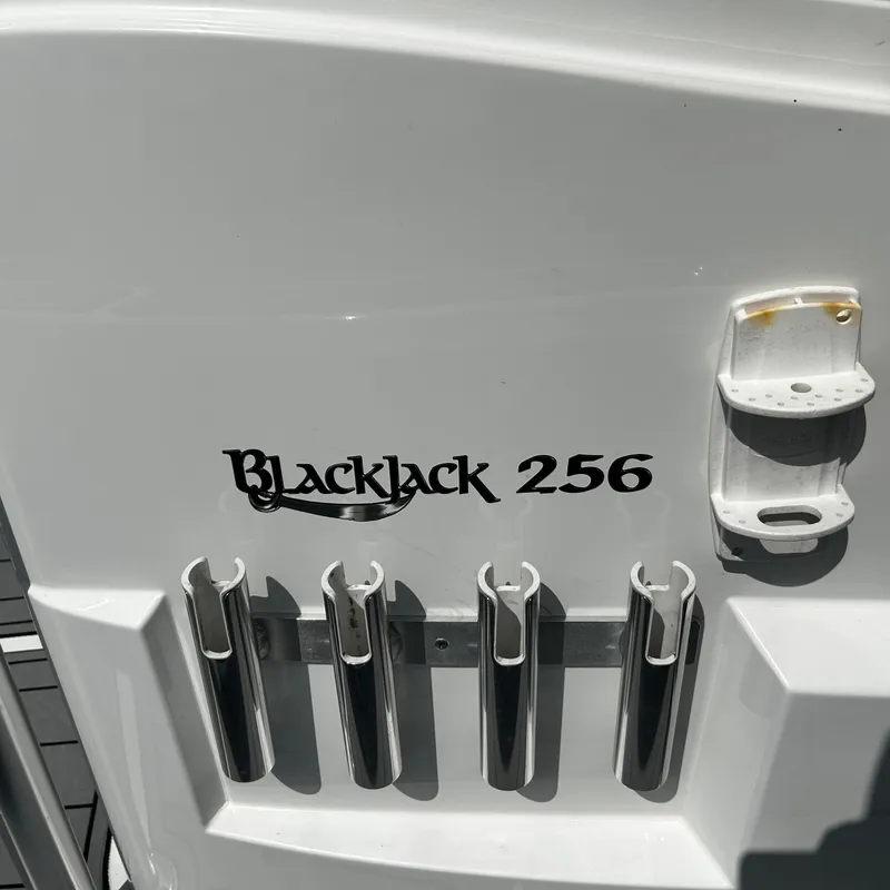 Slide: The Image of 2021 BlackJack 256 Bay boat with rod holders and logo detail. - 18