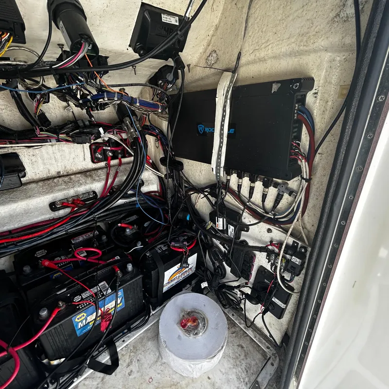 Slide: The Image of 2021 BlackJack 256 Bay boat electrical wiring and battery compartment. - 23