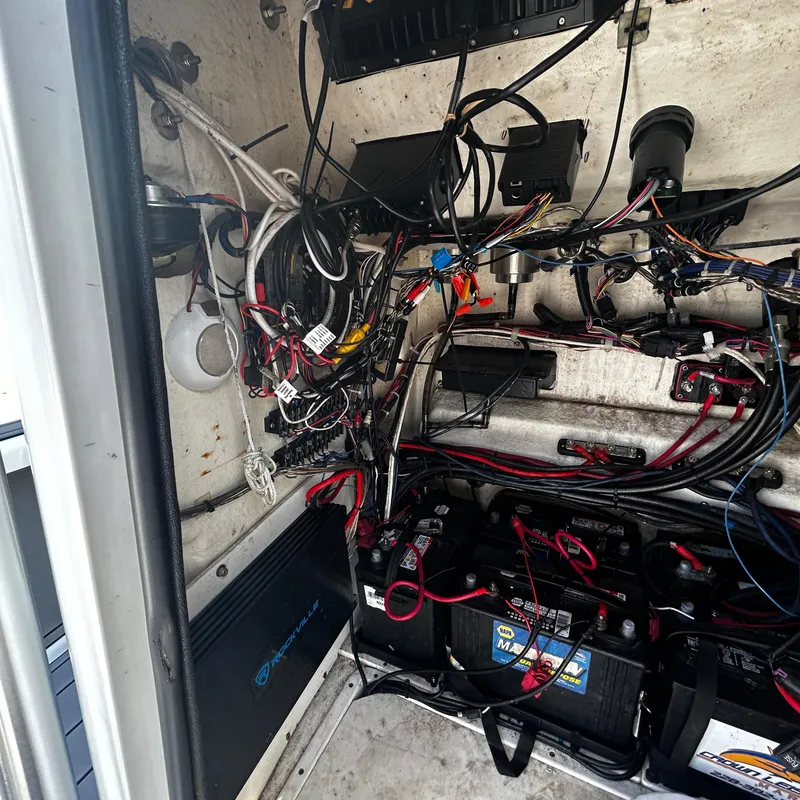 Slide: The Image of 2021 BlackJack 256 Bay boat wiring and battery compartment. - 24