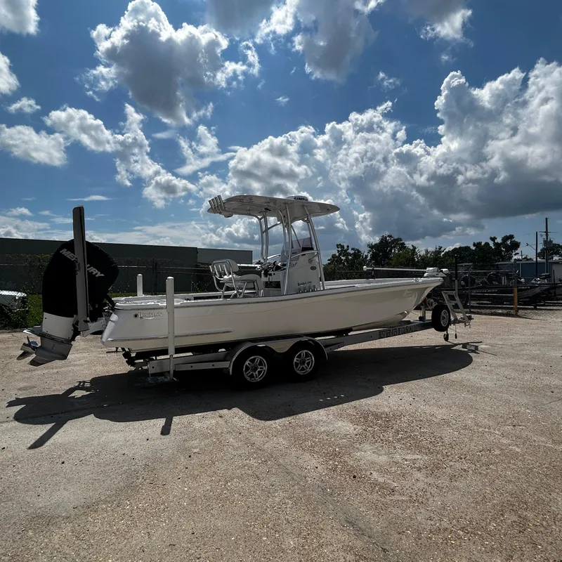Slide: The Image of 2021 BlackJack 256 Bay boat on trailer under cloudy sky. - 3