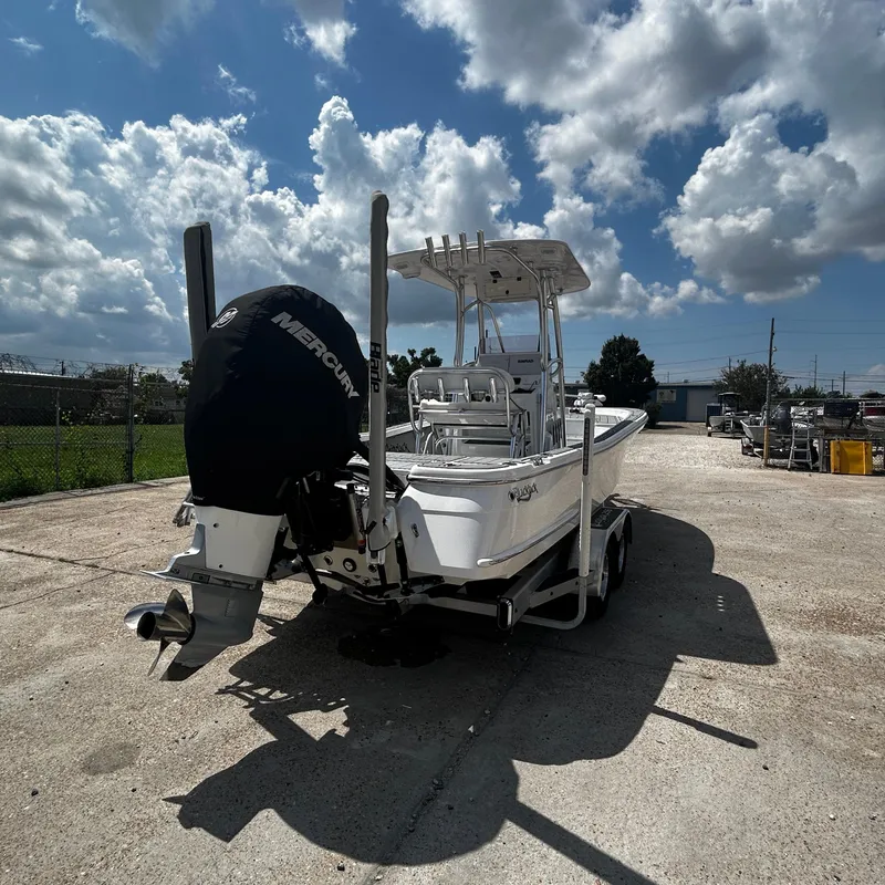 Slide: The Image of 2021 BlackJack 256 Bay boat with Mercury engine on trailer under cloudy sky. - 4