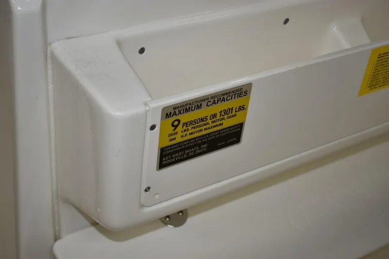 Slide: The Image of 2024 Key West 239 FS boat capacity label, maximum 9 persons or 1301 lbs. - 12