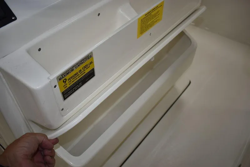 Slide: The Image of 2024 Key West 239 FS boat storage compartment with capacity label. - 13