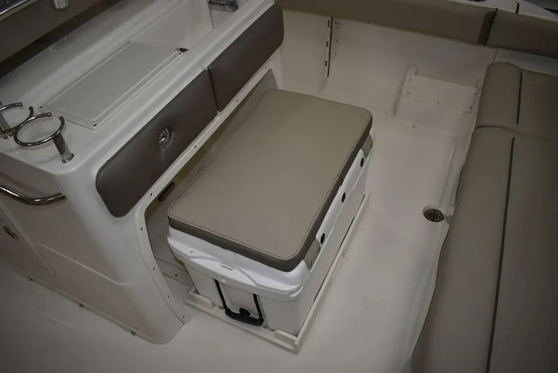 Slide: The Image of 2024 Key West 239 FS boat interior with cushioned seating and storage area. - 17