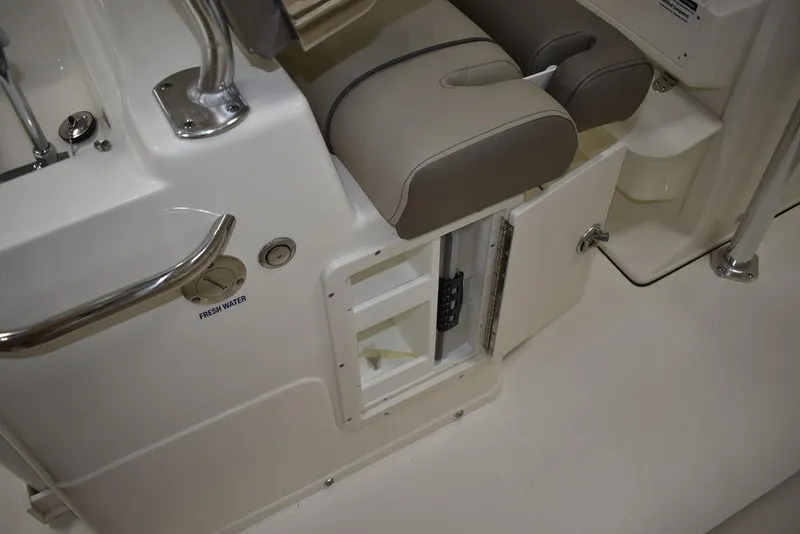Slide: The Image of 2024 Key West 239 FS boat interior with storage compartment and cushioned seating. - 18