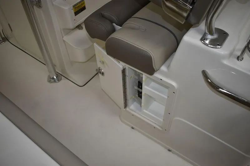 Slide: The Image of 2024 Key West 239 FS boat interior with open storage compartment and cushioned seating. - 19