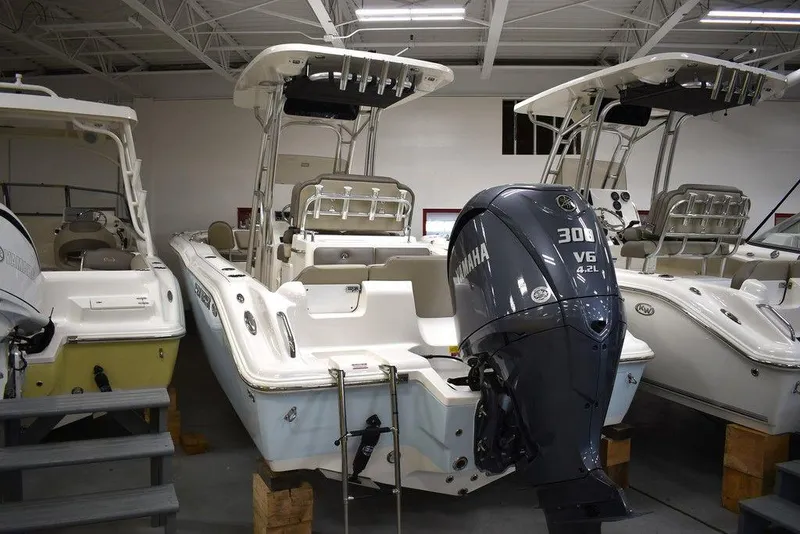 Slide: The Image of 2024 Key West 239 FS boat with Yamaha 300 V6 engine in showroom. - 2