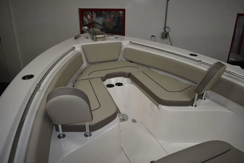 Slide: The Image of 2024 Key West 239 FS boat interior with cushioned seating and cup holders. - 21