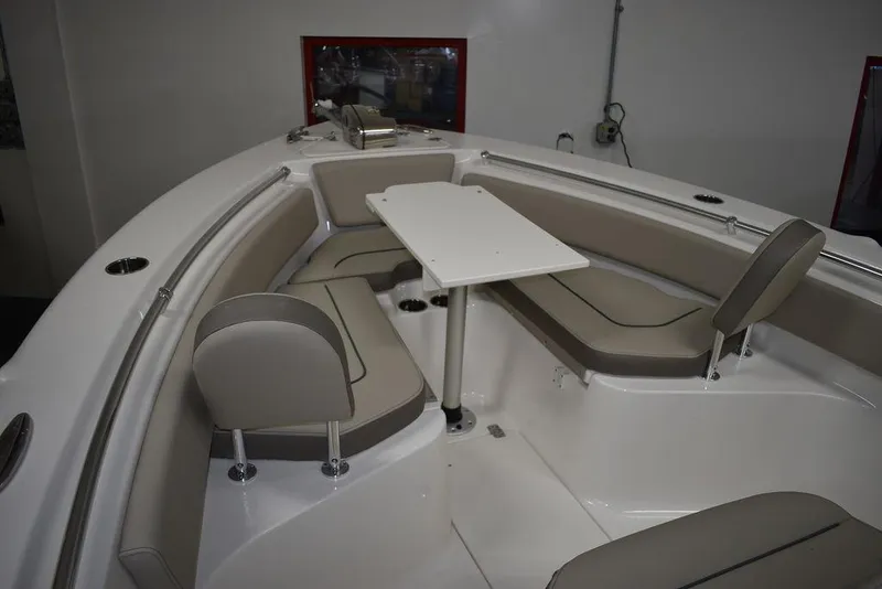 Slide: The Image of 2024 Key West 239 FS boat interior with cushioned seating and table. - 22