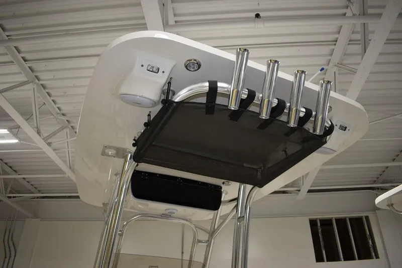Slide: The Image of 2024 Key West 239 FS boat T-top with rod holders in a showroom. - 29