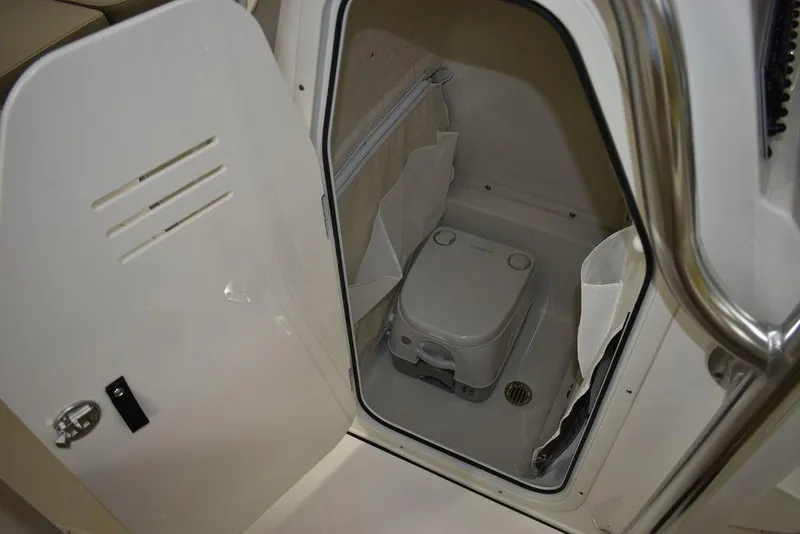 Slide: The Image of 2024 Key West 239 FS boat interior with compact marine toilet. - 33