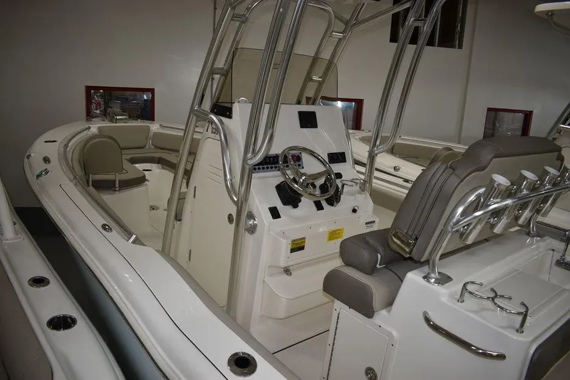 Slide: The Image of 2024 Key West 239 FS boat interior with helm, seating, and stainless steel accents. - 8