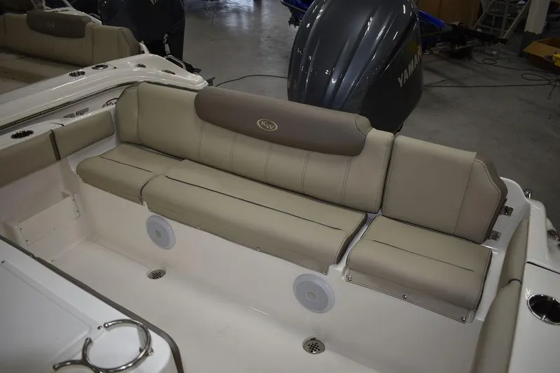 Slide: The Image of 2024 Key West 239 FS boat interior with beige seating and Yamaha engine. - 9