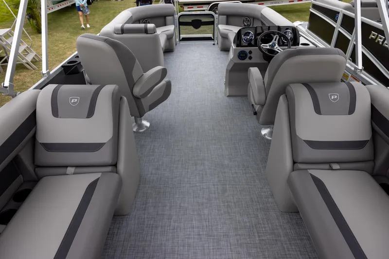 Slide: The Image of 2025 Premier 220 Sunscape RF pontoon boat interior with gray seating and modern dashboard. - 13