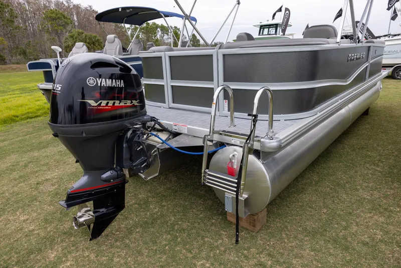 Slide: The Image of 2025 Premier 220 Sunscape RF pontoon boat with Yamaha VMAX outboard motor, displayed on grass. - 2