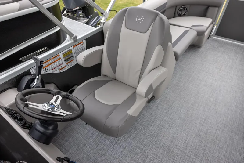 Slide: The Image of 2025 Premier 220 Sunscape RF boat interior with captain's chair and steering wheel. - 8