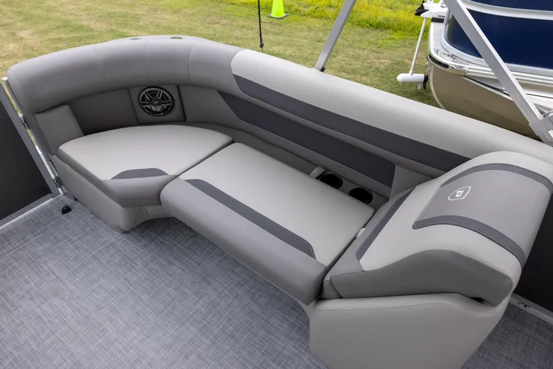 Slide: The Image of Premier 220 Sunscape RF 2025 boat interior with gray seating and speaker, on a textured floor. - 9