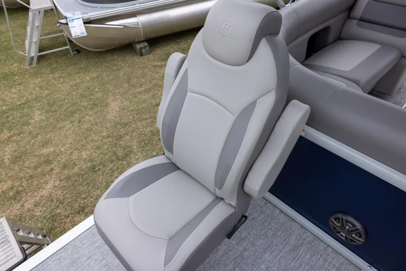 Slide: The Image of 2025 Premier 230 SunSation Angler boat seat, gray upholstery, armrests, outdoor setting. - 13