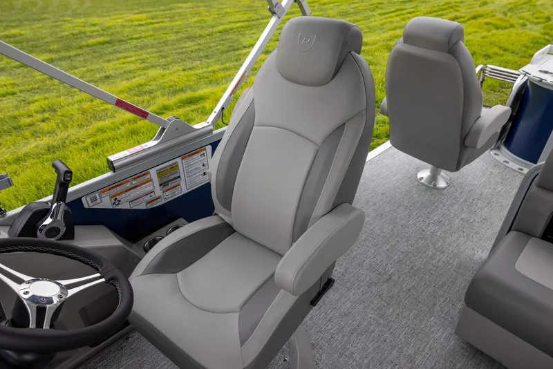 Slide: The Image of 2025 Premier 230 SunSation Angler boat interior with comfortable seating and steering wheel. - 8