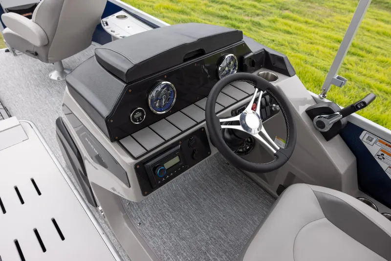 Slide: The Image of 2025 Premier 230 SunSation Angler boat dashboard with steering wheel and controls. - 9
