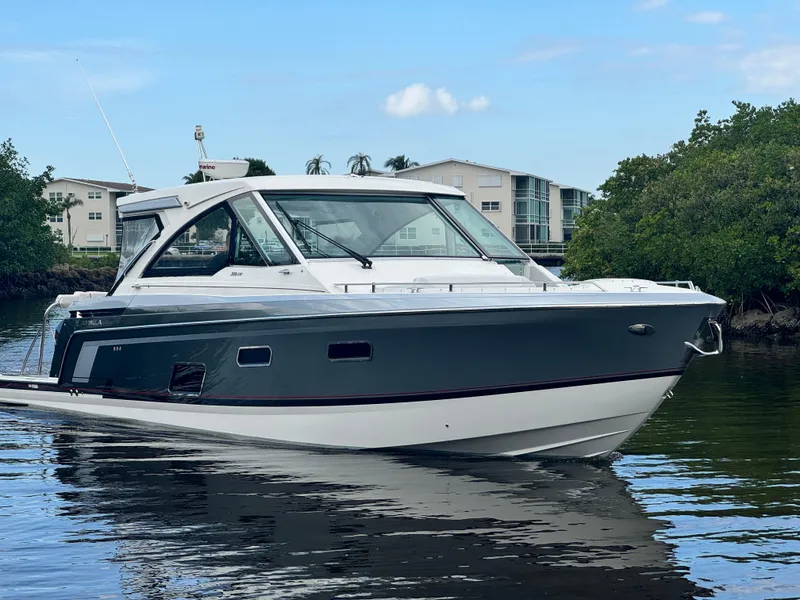 Slide: The Image of 2021 Formula 380 Super Sport Crossover OB boat on calm water, modern design. - 0