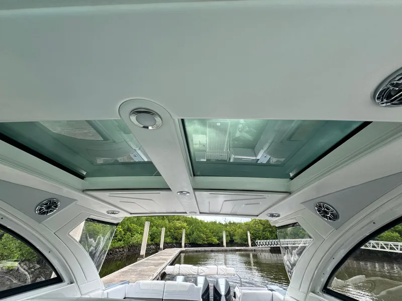 Slide: The Image of Interior view of 2021 Formula 380 Super Sport Crossover OB with glass roof and dockside scenery. - 12
