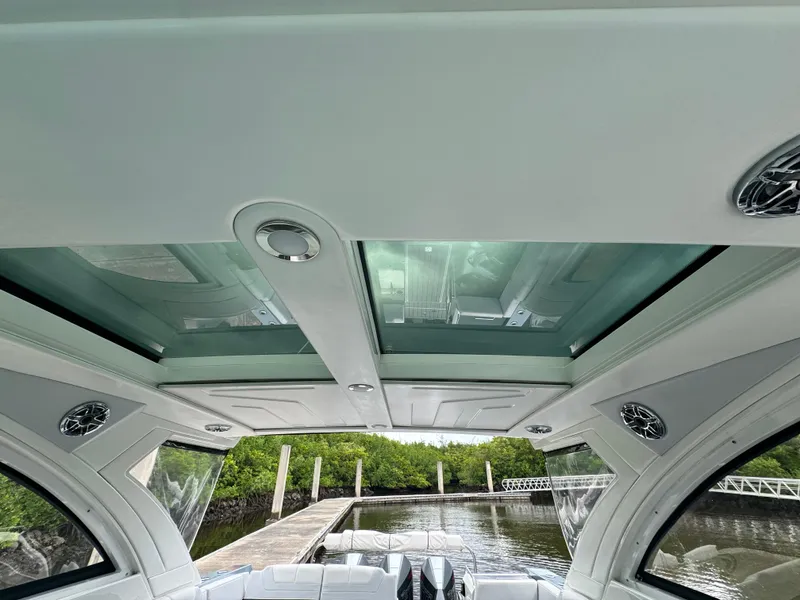 Slide: The Image of Interior view of 2021 Formula 380 Super Sport Crossover OB with glass roof and dock background. - 15