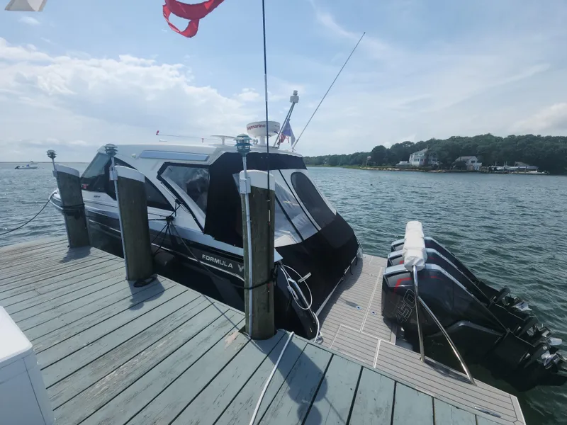 Slide: The Image of 2021 Formula 380 Super Sport Crossover OB docked by the water. - 16