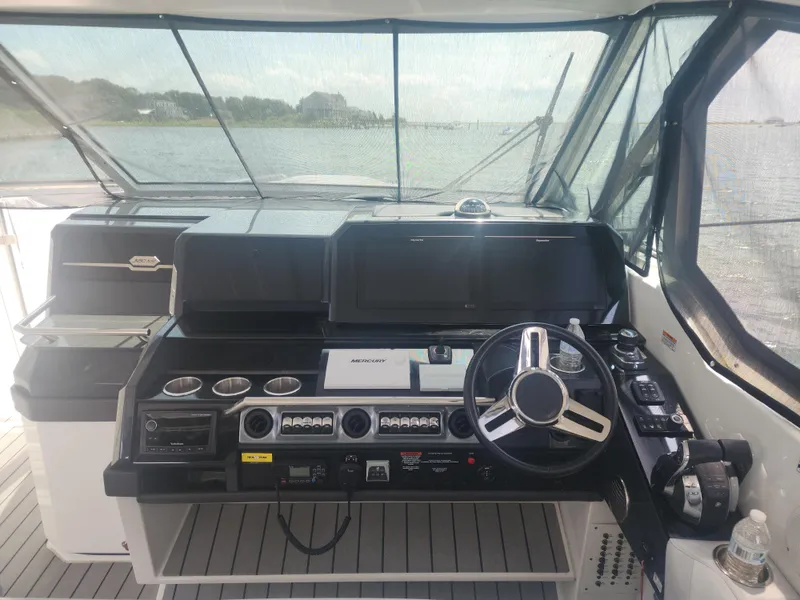 Slide: The Image of 2021 Formula 380 Super Sport Crossover OB helm with modern controls and navigation screens. - 19