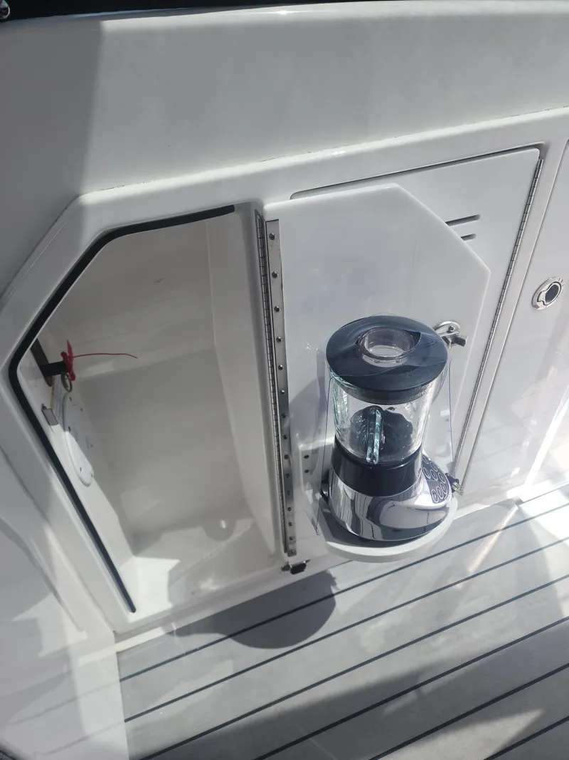 Slide: The Image of 2021 Formula 380 Super Sport Crossover OB boat deck with blender and storage compartment. - 27