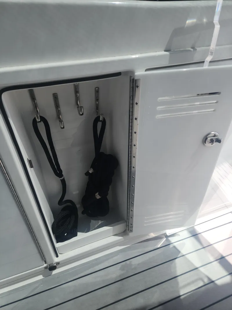 Slide: The Image of Open storage compartment on 2021 Formula 380 Super Sport Crossover OB boat. - 28