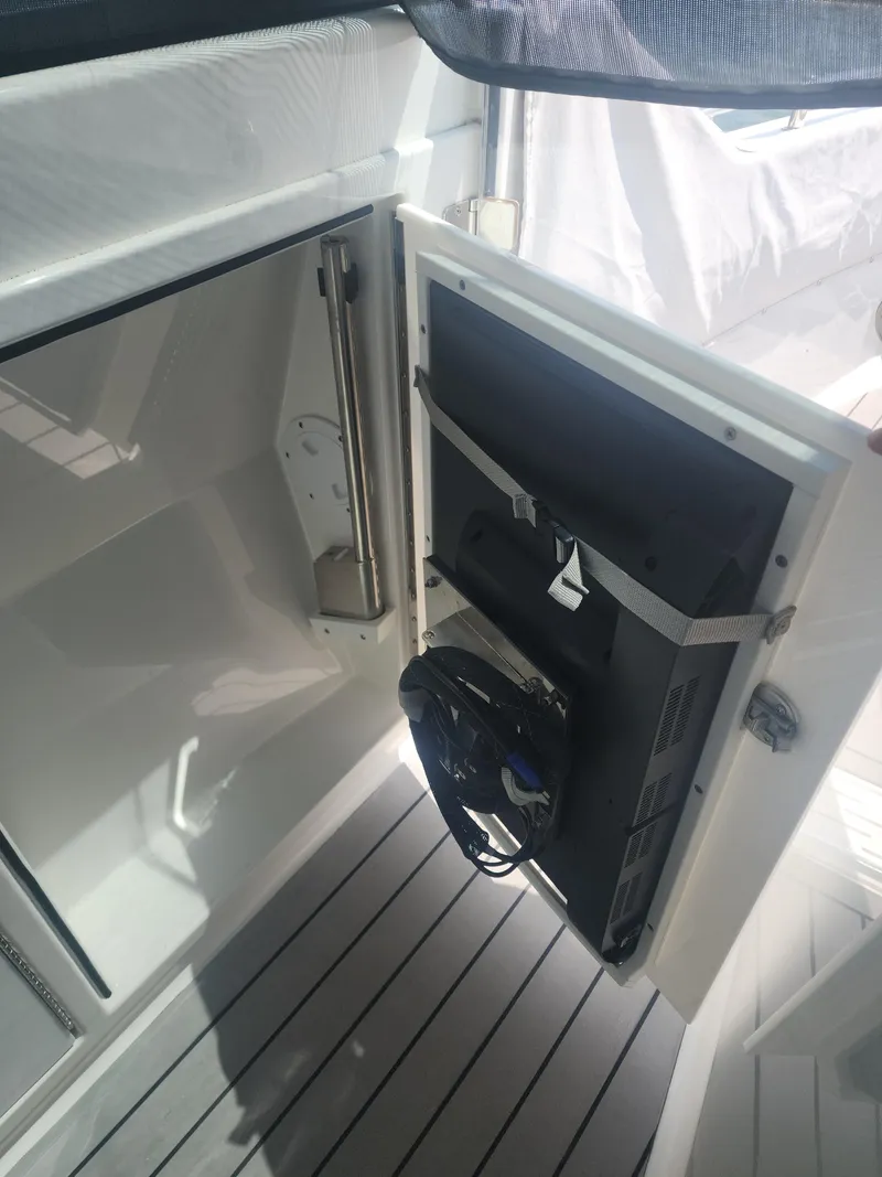 Slide: The Image of 2021 Formula 380 Super Sport Crossover OB interior with open storage compartment. - 29