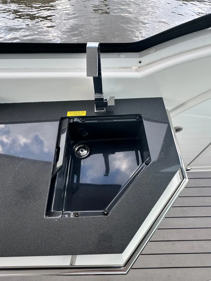 Slide: The Image of 2021 Formula 380 Super Sport Crossover OB boat sink with sleek black countertop. - 35