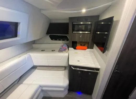 Slide: The Image of 2021 Formula 380 Super Sport Crossover OB interior with modern seating and kitchenette. - 38