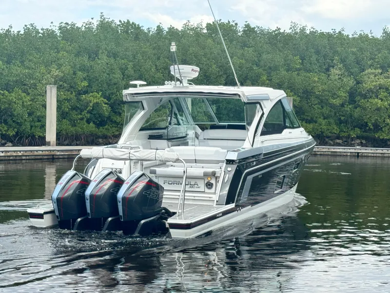 Slide: The Image of 2021 Formula 380 Super Sport Crossover OB boat with triple outboard engines on water. - 4