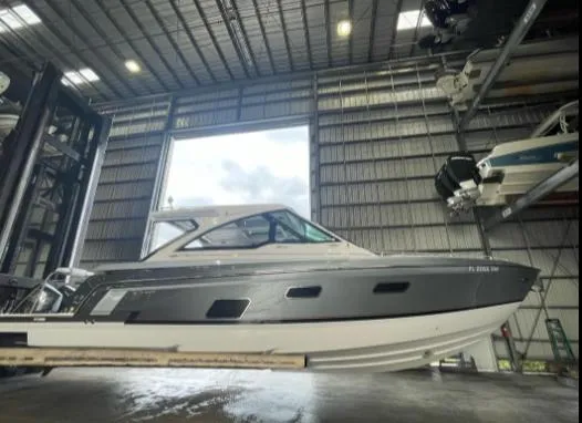 Slide: The Image of 2021 Formula 380 Super Sport Crossover OB in a spacious indoor storage facility. - 6