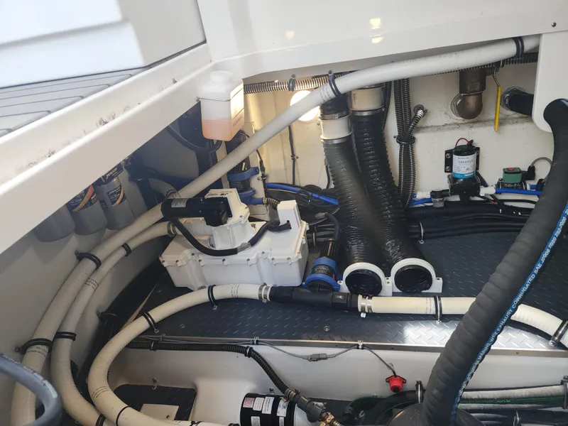 Slide: The Image of Engine compartment of 2021 Formula 380 Super Sport Crossover OB, showcasing hoses and components. - 68