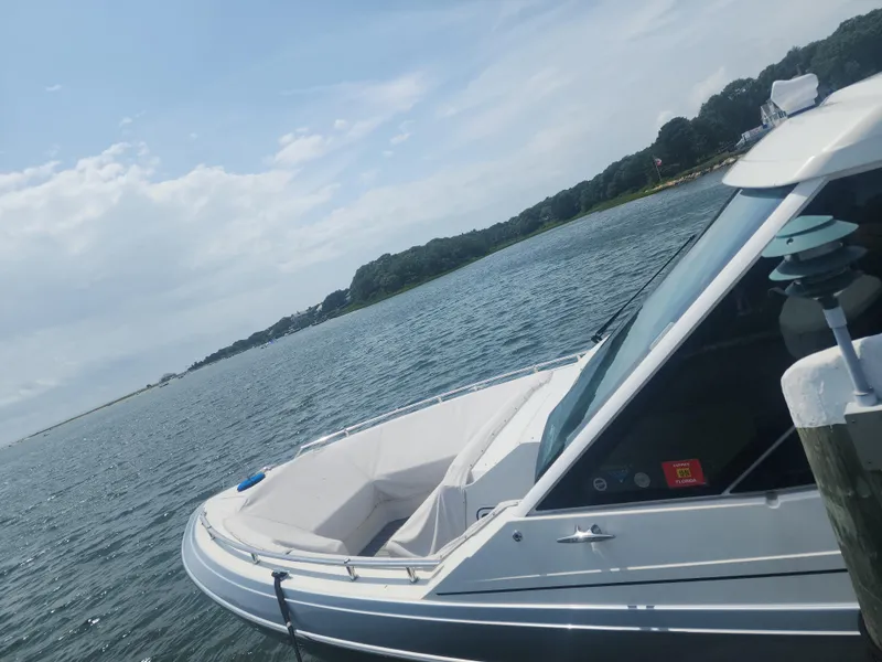 Slide: The Image of 2021 Formula 380 Super Sport Crossover OB docked by scenic shoreline. - 9