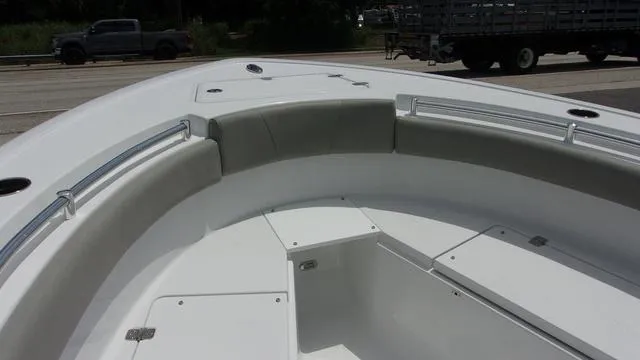 Slide: The Image of 2025 Sportsman Open 212 boat interior with cushioned seating and storage compartments. - 10
