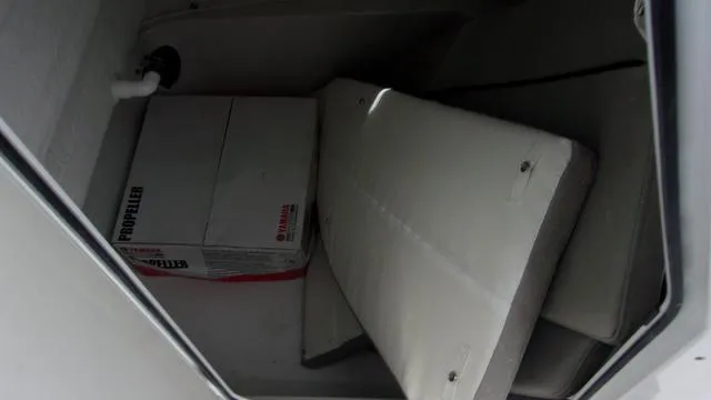Slide: The Image of Storage compartment in 2025 Sportsman Open 212 boat with Yamaha propeller box. - 14