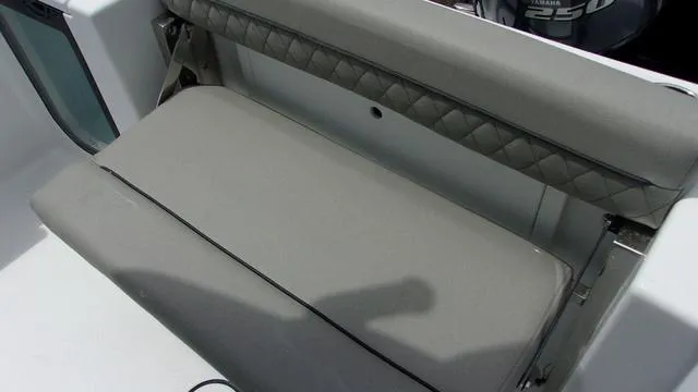 Slide: The Image of 2025 Sportsman Open 212 boat seat with gray upholstery and diamond-patterned backrest. - 15