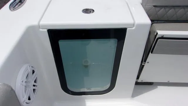 Slide: The Image of 2025 Sportsman Open 212 boat interior detail with storage compartment and speaker. - 16