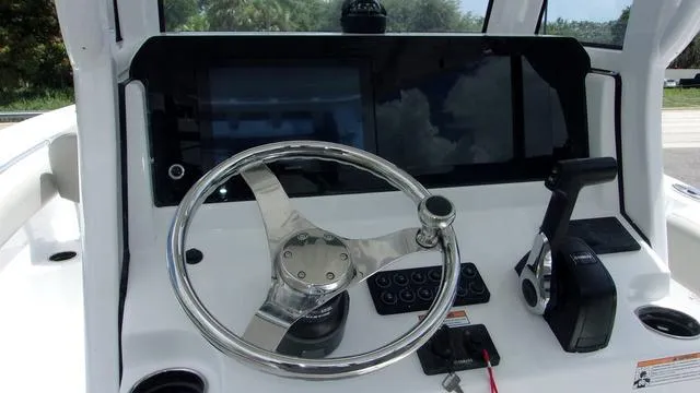 Slide: The Image of 2025 Sportsman Open 212 boat dashboard with steering wheel and controls. - 6