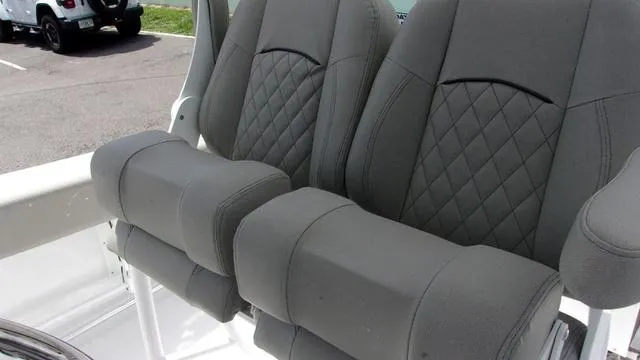 Slide: The Image of 2025 Sportsman Open 212 boat seats with diamond-stitched gray upholstery. - 8