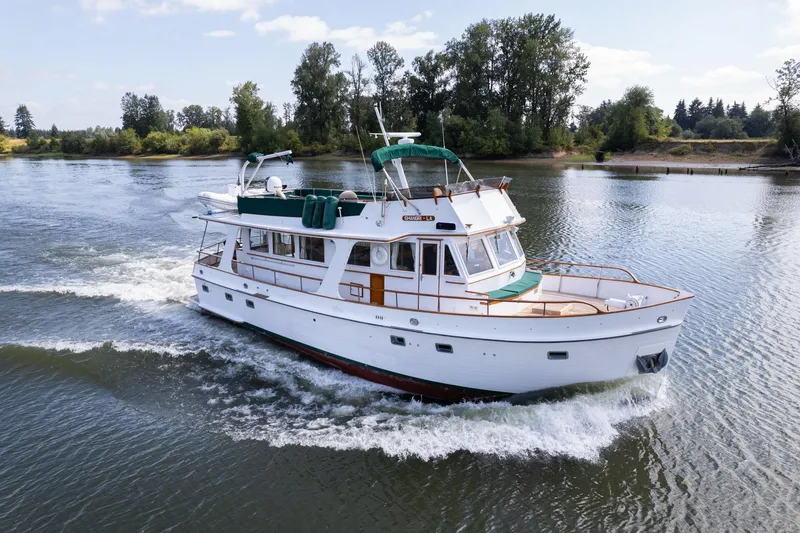 Slide: The Image of 1976 Grand Banks 52 Europa yacht cruising on a serene river. - 1