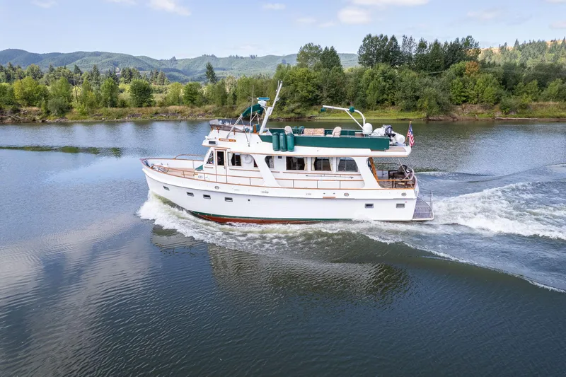 Slide: The Image of 1976 Grand Banks 52 Europa yacht cruising on a serene river. - 2